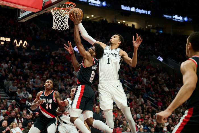 Dec 28, 2023; Portland, Oregon, USA; San Antonio Spurs center Victor Wembanyama (1) blocks a shot during the first half against Portland Trail Blazers guard Scoot Henderson (00) at Moda Center.